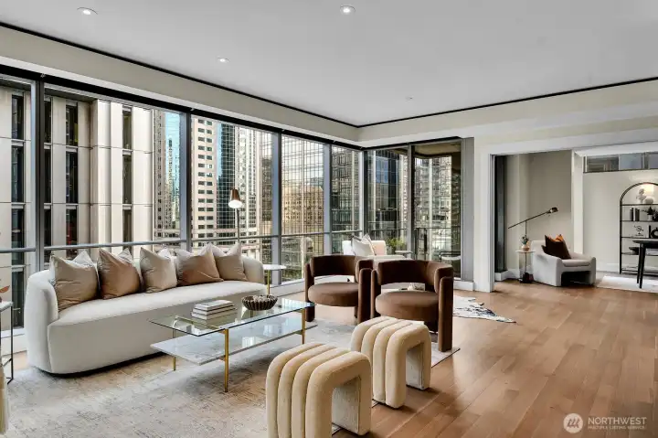 The living room flows into a den/office and out to a private terrace.