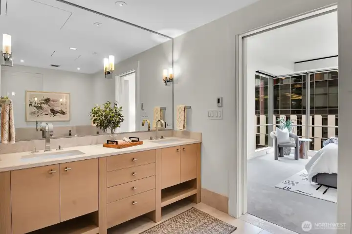 Double vanities and heated floors are found in the primary bathroom.