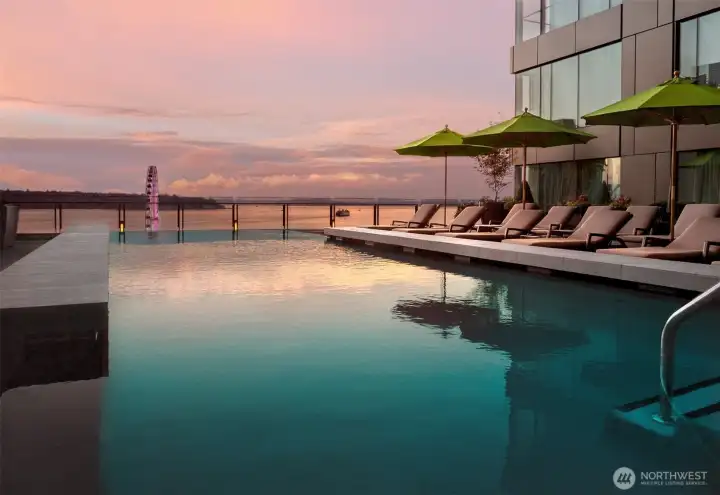 Amazing sound and mountain views are enjoyed from the infinity pool, hot tub and fire pit  on the 4th floor terrace just outside the fitness center and spa.