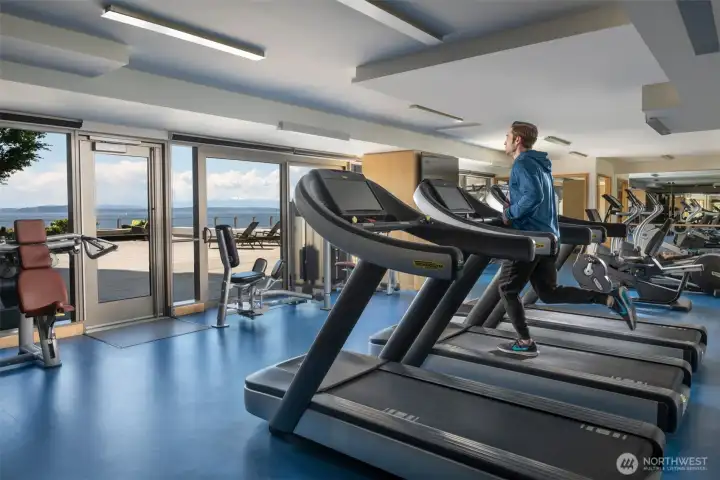 The fitness center looks out to the pool terrace on the 4th floor.