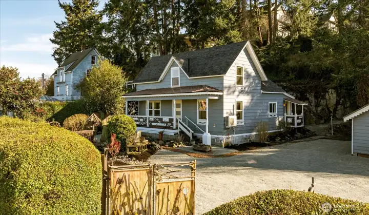 Inside the gated entry, a spacious courtyard and detached shop create flexibility for hobbies, studio space, or projects.