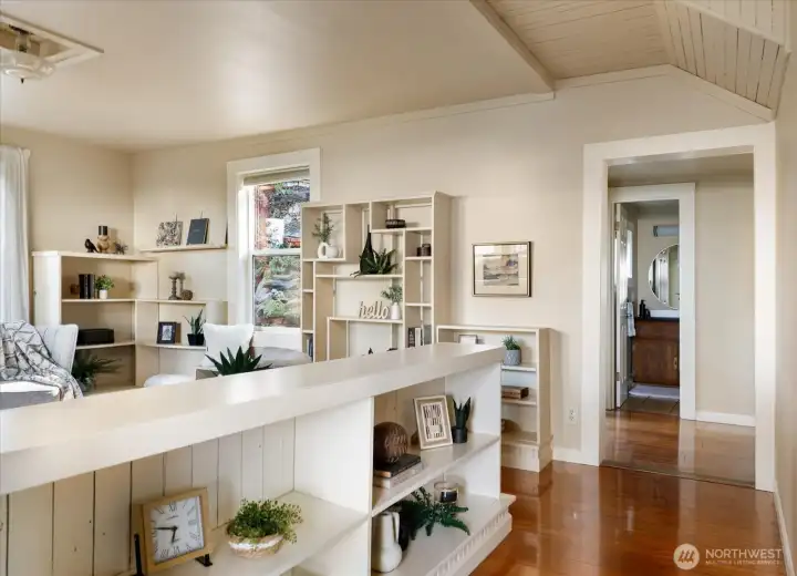 The open flow between living room and dining area creates a comfortable rhythm to the home — spaces that feel connected yet distinct.