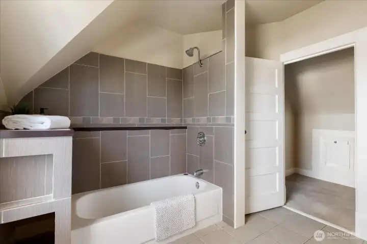 A beautifully updated bathroom with full tile surround offers a clean, timeless look and comfortable space for everyday routines.