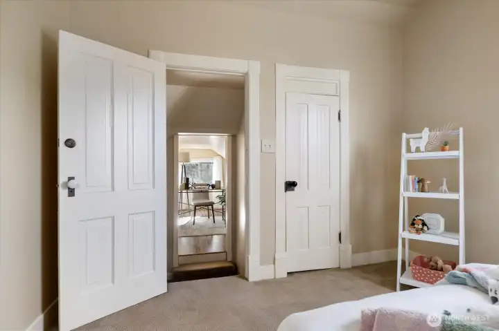 Classic doors and warm neutral tones create a charming upstairs landing that connects the bedrooms and loft space.