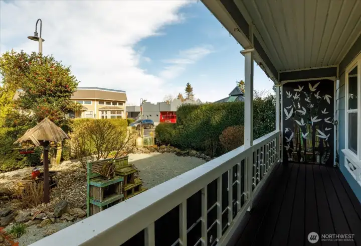 From the covered front porch, the garden unfolds with sculptural details and carefully shaped greenery- a peaceful place to sit with coffee and watch the rhythm of town life.