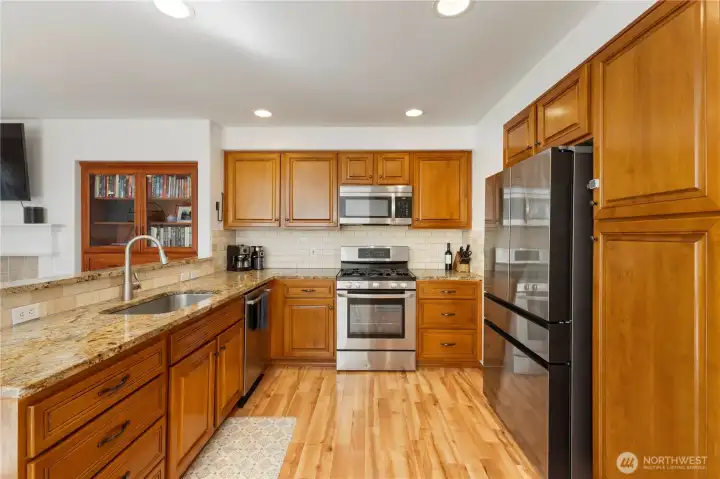 Open kitchen with stainless steel appliances. All appliances stay!