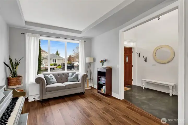 Bright formal living room with large windows and natural light