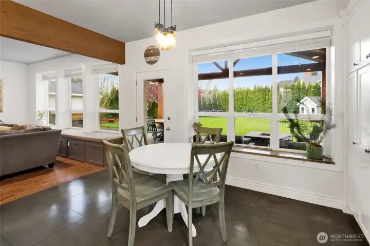 Dining area with views of backyard and patio