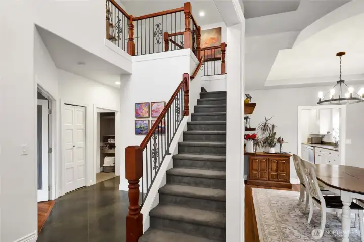 Entry and staircase with open railing and natural light