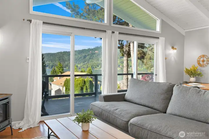 Vaulted ceilings and expansive windows frame lake and mountain views from the main living area.