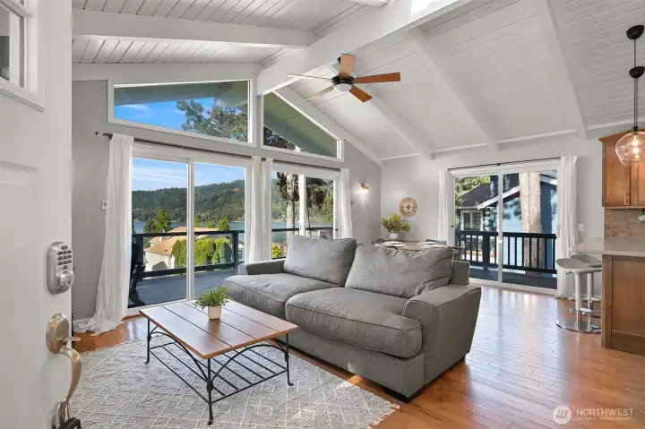 Open-concept great room with stunning lake views, vaulted ceilings and large windows that create a bright and welcoming atmosphere.