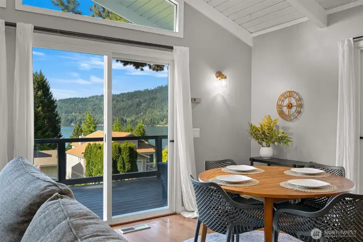 Dining area positioned to capture natural light and Lake Whatcom views while offering direct access to the deck.