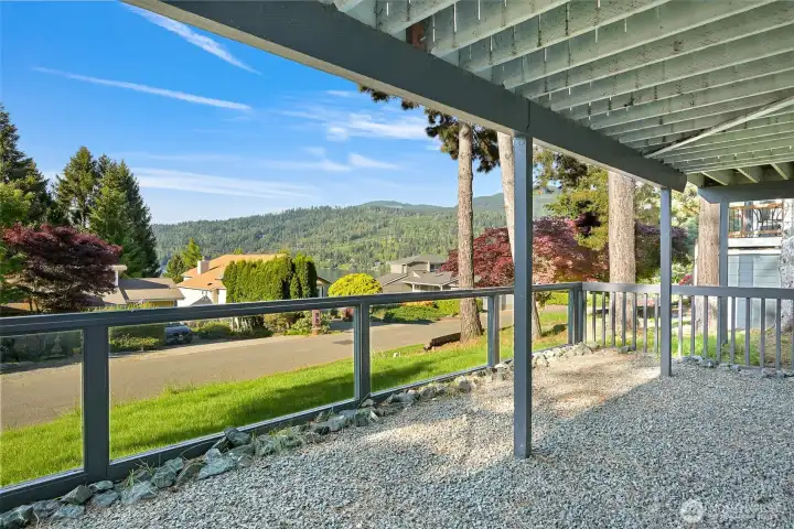 The primary suite opens to a lower-level patio and   captures lake and mountain views in a peaceful setting.