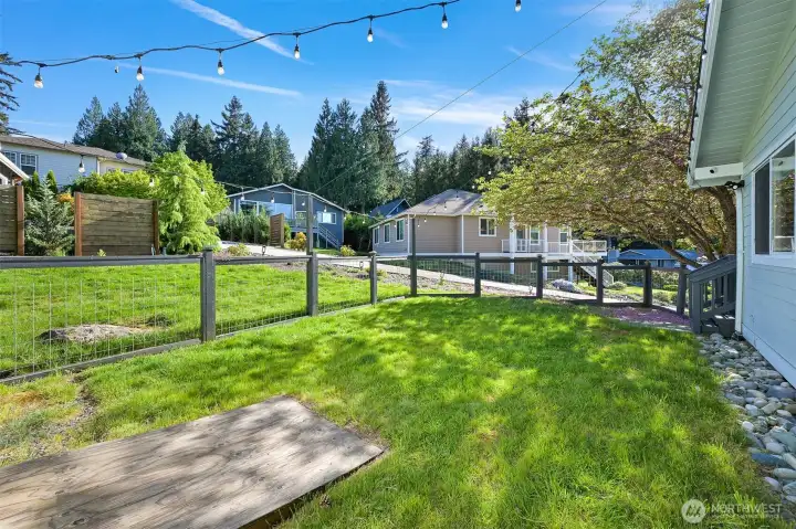 Fenced yard accommodates a golf cart and provides usable outdoor space with room for gardening, pets, or recreation.
