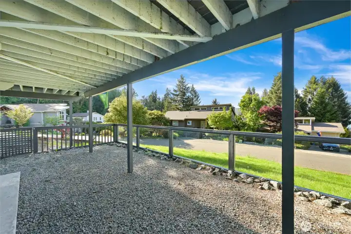 Covered lower patio offers flexible outdoor living space with room to relax or entertain.