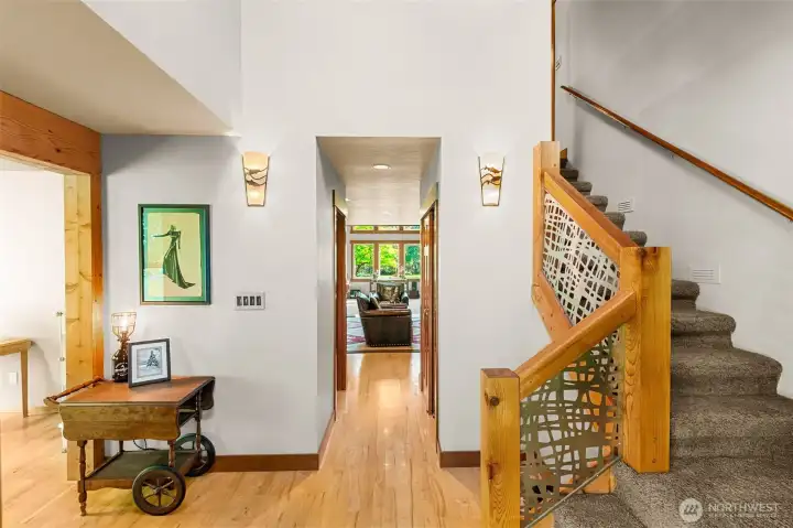 Welcome home! Beautiful, warm hardwood floors and custom stair railing greet you at the entry. Room to the left is an art or craft space, or office.