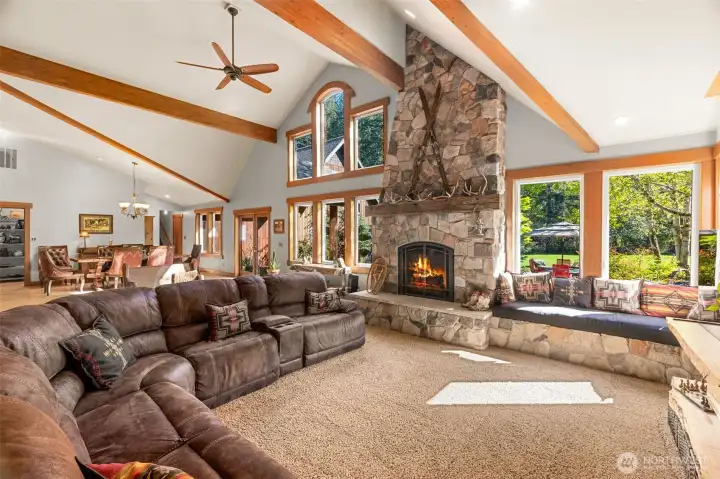 Cozy gas fireplace with a reclaimed barn wood mantle, generous hearth and wrap around seating will be the gathering spot