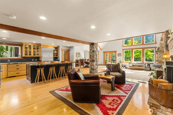 Den/seating area off kitchen is a nice spot for friends and family to be a part of the kitchen action while relaxing with snacks by the crackling wood burning stove