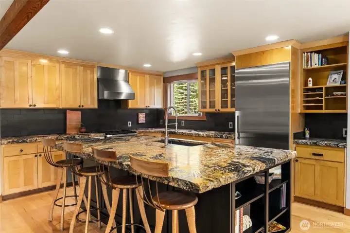 What a kitchen! With live edge, extra thick slab granite counters, full height slate tile backsplash and luxury appliances, you may not want to leave!