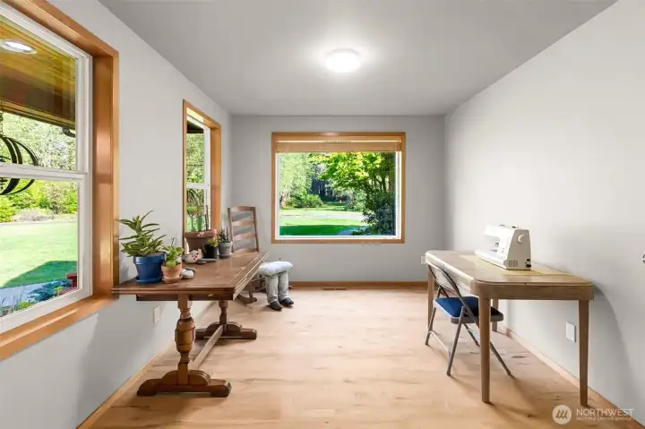 This front room makes a wonderful art or craft room, with lots of great light and views across the front porch