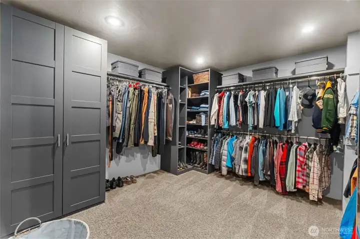 A proper primary walk in closet with built in storage customized to optimize this space