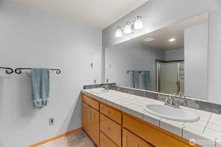 Main floor laundry room/mud room adjoins the garage. It features plenty of storage with a sturdy stainless utility sink plus rubber floors for durability and easy cleaning