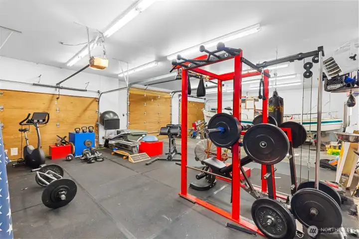 The garage has six bays,  with one over-height door. Owners have more than enough covered parking, so they are using this bay as another fitness area.