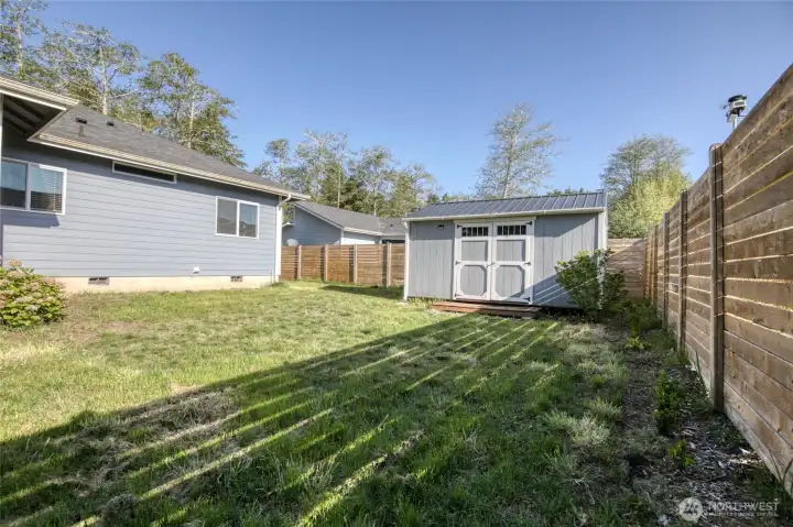 Outbuilding and backyard fence