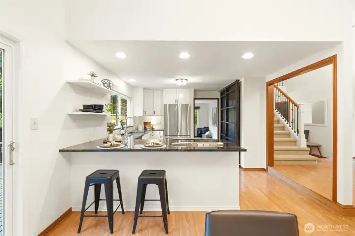 The spacious kitchen features bar seating and a pantry.