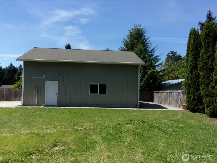 East side of the detached garage/shop features paved parking and man door.