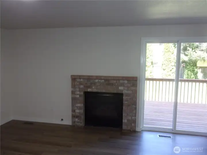 Bricked gas fireplace with new deck to the right.