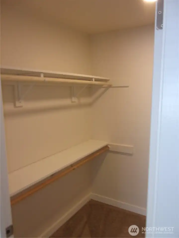 Primary bedroom walk-in closet.