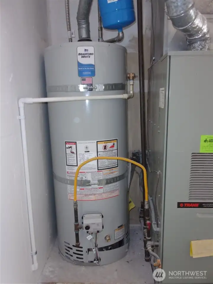 The force air gas furnace and the new water heater are located in the attached garage.