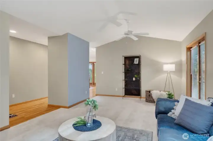 The living room is just off the front entry and has vaulted ceilings with skylights allowing natural sunlight.