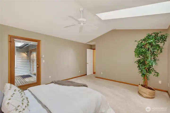 The primary suite opens onto the large back deck and is very private.