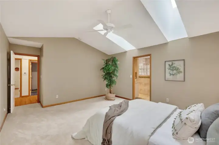 Looking across the spacious primary bedroom toward the laundry and 2nd bedroom.