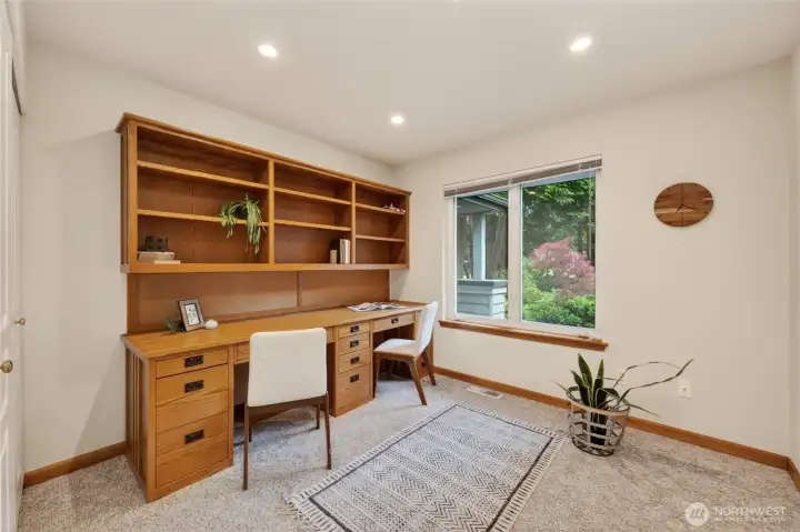 The 2nd bedroom has a built-in desk and bookcases and looks out toward the front of the home.