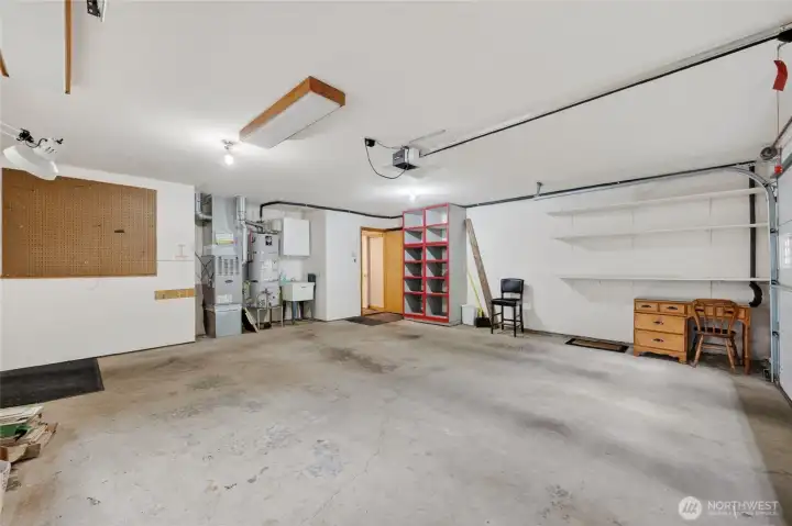 The garage is spacious and houses the gas forced air furnace and hot water heater and there is also a deep sink there.