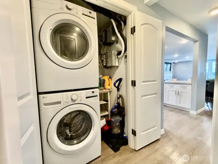 Unit B stacked washer and dryer in hallway. Unit A has the same.