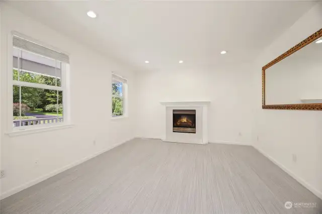 Formal Living Room  Carpeted  Cozy gas fireplace with footed wood mantle and quartz surround  Built in book shelf