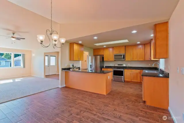 Open concept with some delineation - Large open kitchen w/ skylight