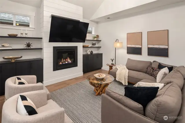 Gas fireplace with custom built-in upgrades are the centerpiece of the generous living room