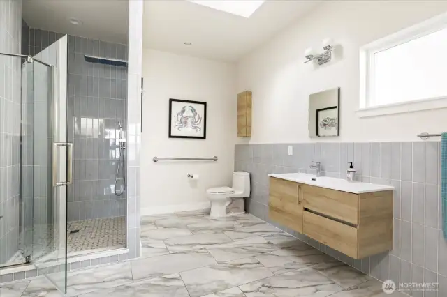 The primary bath with a gorgeous custom shower and ample space to get ready.