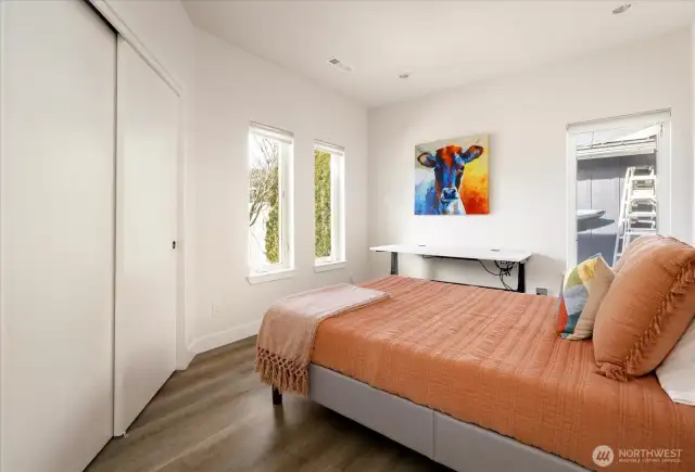 Bedroom one with views of the front landscape.