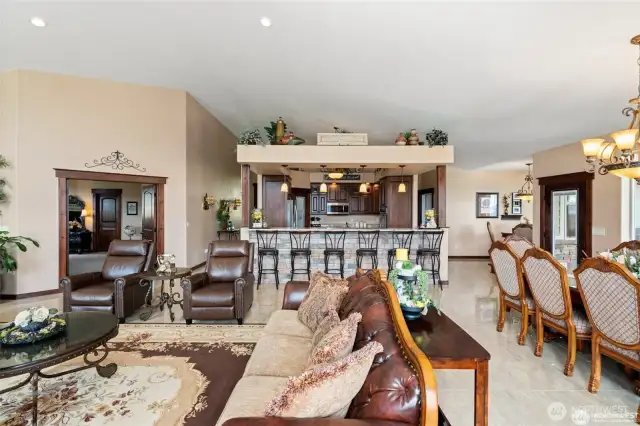 Looking from living room into kitchen. Primary bedroom is to the left and dining room & breakfast nook are to the right.
