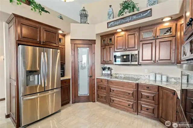 Stainless Steel appliances and walk-in pantry.