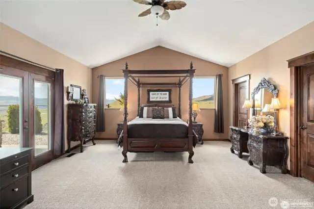 Primary bedroom with vaulted ceilings.
