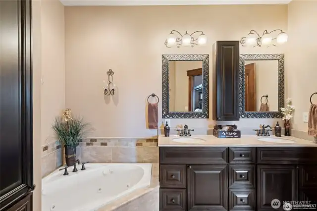 Primary bathroom with double sinks/vanities and a jetted tub.