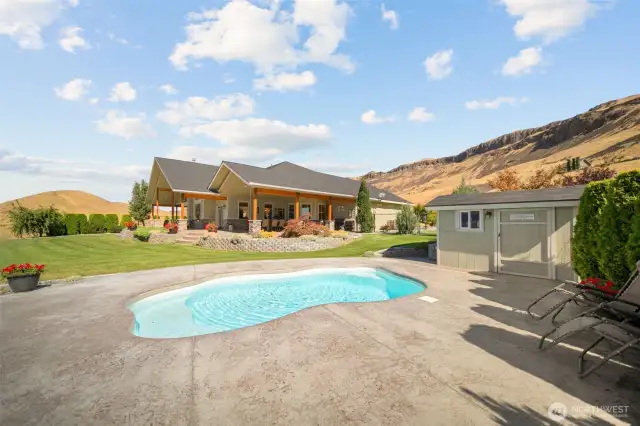 Pool and pumphouse, looking back towards the home and yard.