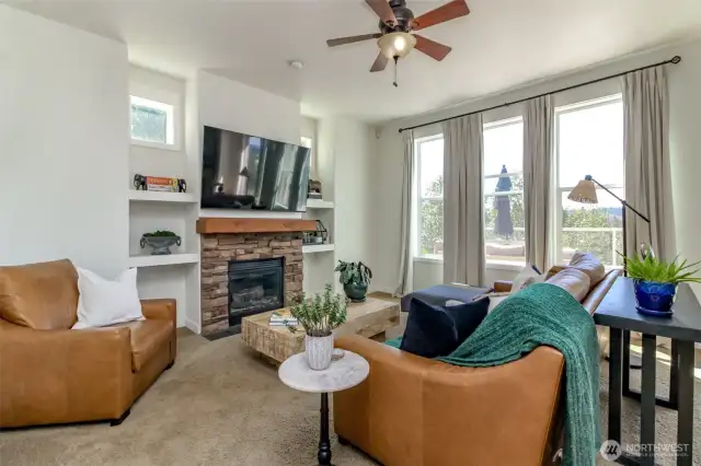 Living, gathering room with cozy gas fireplace and built in shelving